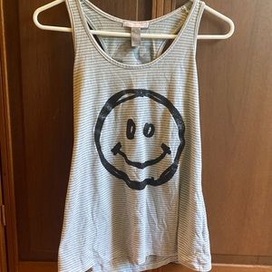 A great and white striped tank top with a smile face and the word smile